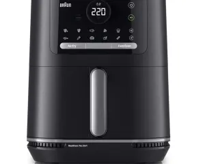 Black Braun Real Oven 2-in-1 countertop air fryer/oven with a central touchscreen display and a vertical silver handle on the front panel, set to 220°C.