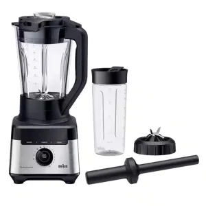 High-power blender with large glass pitcher, travel bottle, blade cap, and tamper accessory set ready for use.