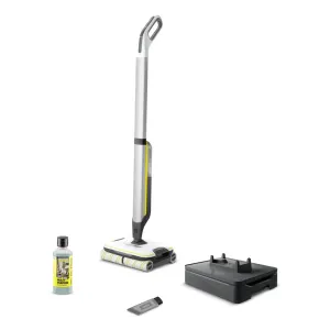 Kärcher cordless floor cleaning system with long white and gray handle, yellow-trim mop head, charging dock, bottle of multi-purpose cleaner, and a small attachment accessory.