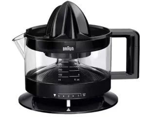 Braun electric citrus juicer with a glass juice container and black base, spout on the side, and reamer on top