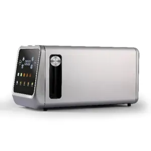 Modern stainless steel toaster oven with a black front control panel and a circular dial on the left side of the door area, placed on a countertop.