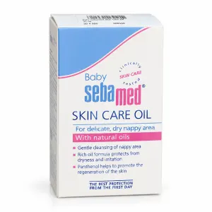 Box of Baby Sebamed Skin Care Oil for delicate, dry nappy areas, featuring blue and pink branding and text about natural oils and gentle cleansing.