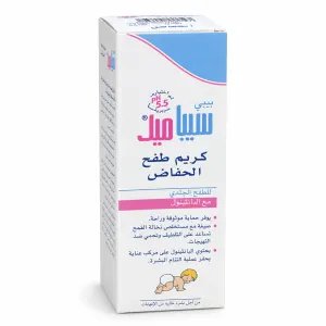 Box of BabyMed diaper rash cream with blue and pink design; Arabic text on packaging and a small illustration of a crawling baby at the bottom.