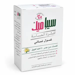 White box packaging for a feminine wash product, with pink and green Arabic branding and a small yellow rose illustration on the front.
