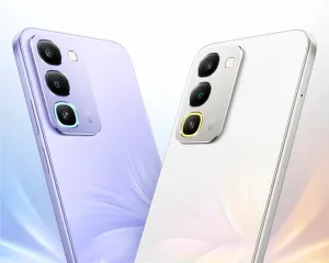 Two Realme smartphones in lavender and silver are angled to show their triple-camera rear modules and glossy finishes.